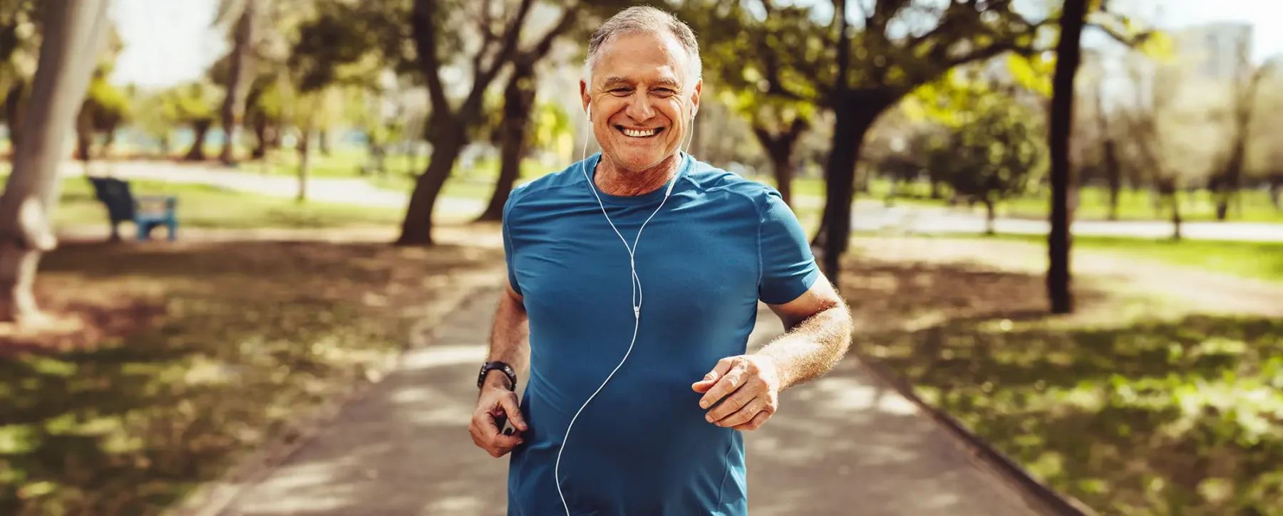 Older man jogging in a park