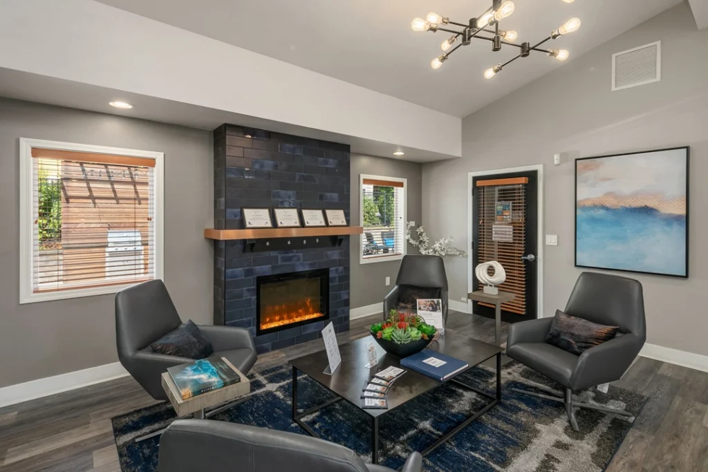 Clubhouse lounge with chairs around a fireplace